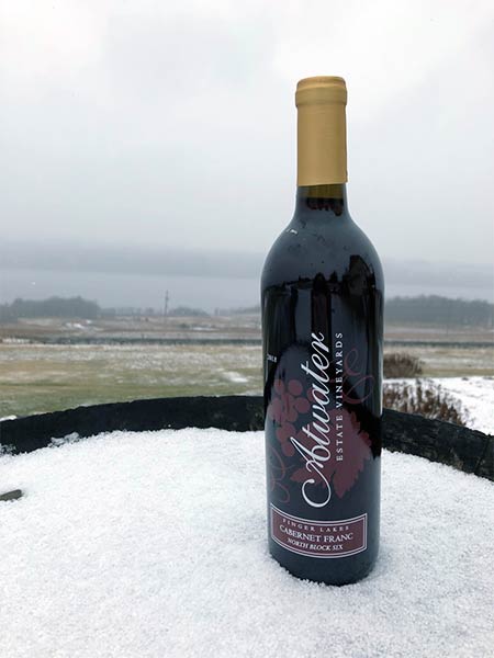 Cabernet Franc sitting on a barrel in the snow.