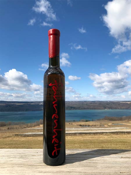 Bottle of Fahrenheit on a table overlooking Seneca Lake